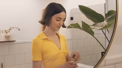 A woman using Brightabs toothpaste tablets, illustrating the product experience.